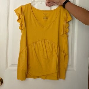 Yellow ruffled shirt.